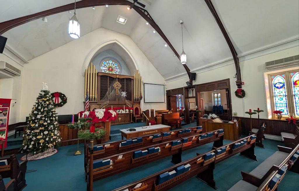 Existing church sanctuary looking toward the organ, chancel and pews