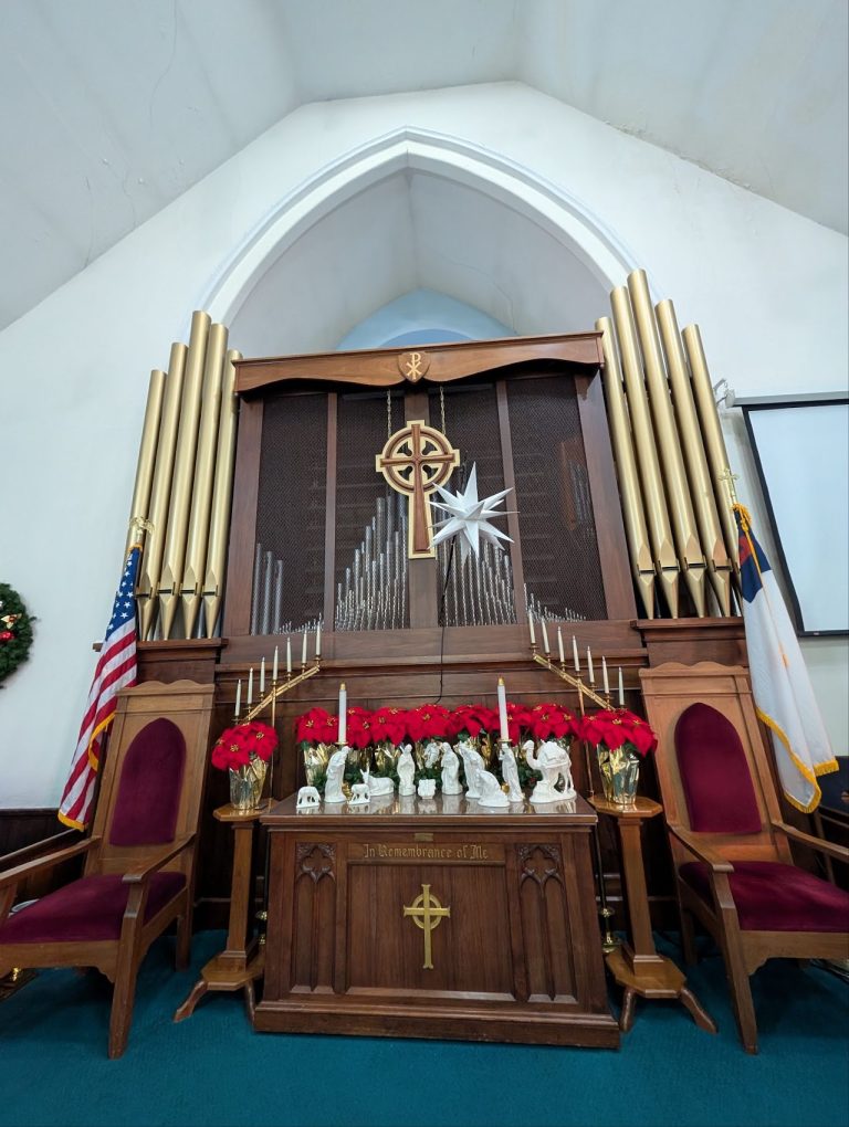 Existing church chancel with wood organ case, altar and seasonal decorations