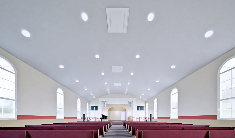 Wide renovation rendering down the church hall with new lighting and red pews