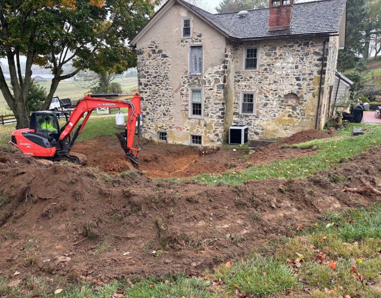Excavation beside the stone farmhouse before construction of the addition