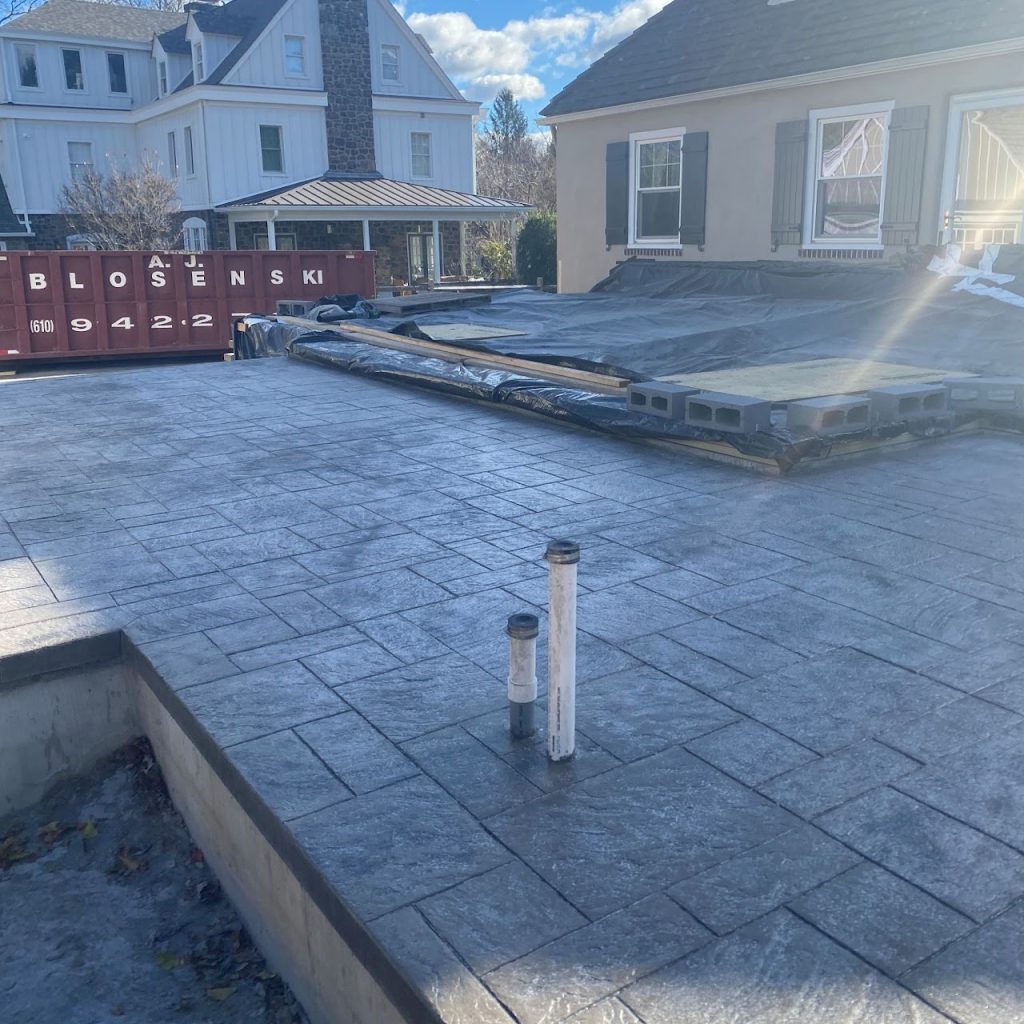 Finished concrete slab for the covered deck and outdoor kitchen