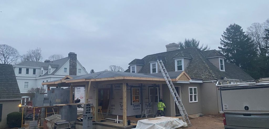 Home addition framing and covered deck roof under construction
