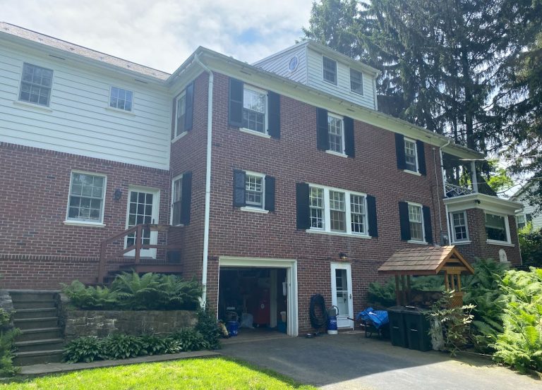 Existing rear elevation of the brick Lancaster home before the garage and deck addition