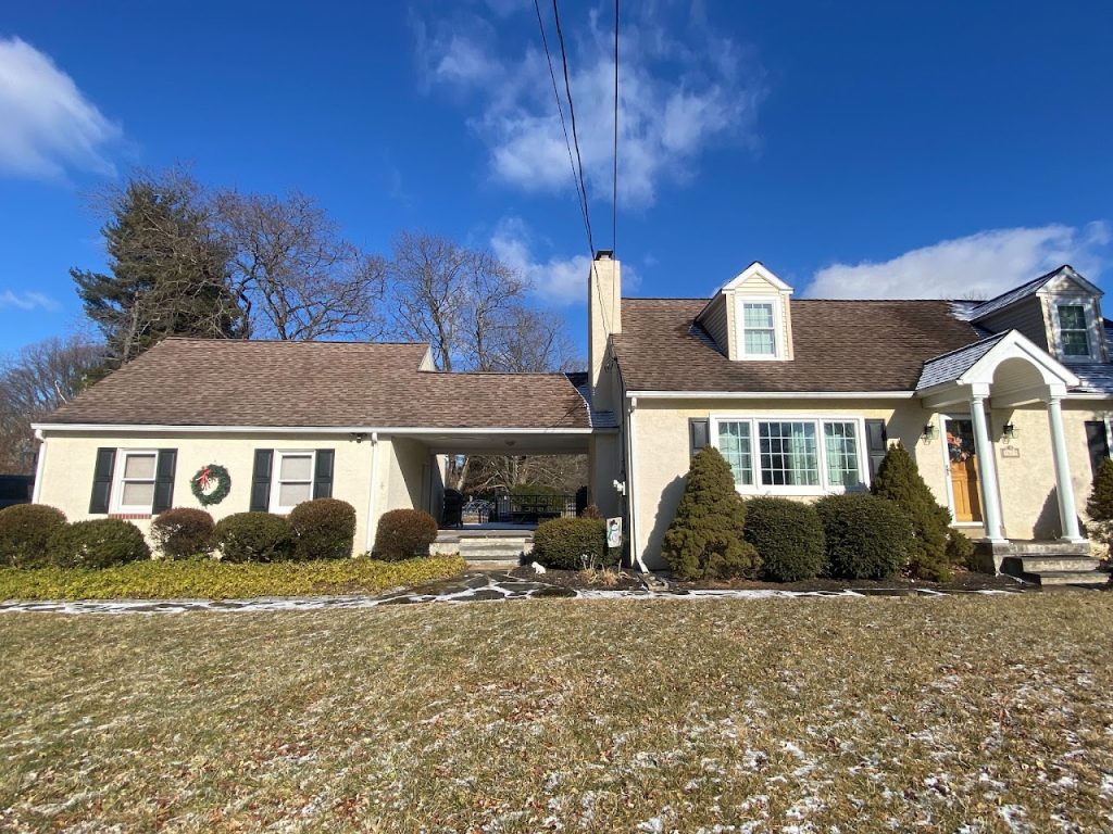 Existing front elevation of the Cape Cod home before the garage addition