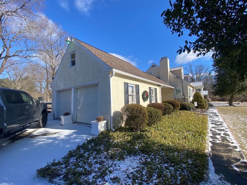 Existing side elevation showing the attached garage and front walkway