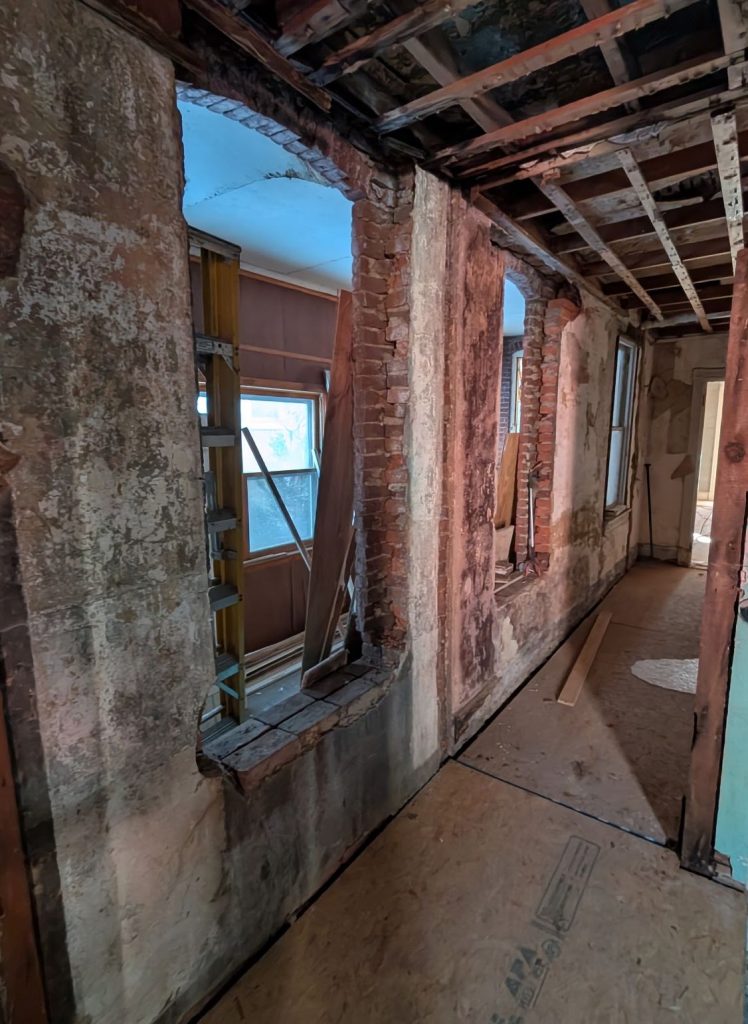Exposed masonry walls and framing inside the Lancaster home renovation