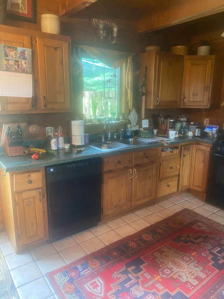 Existing wood kitchen in the Felton log home before the renovation visualization