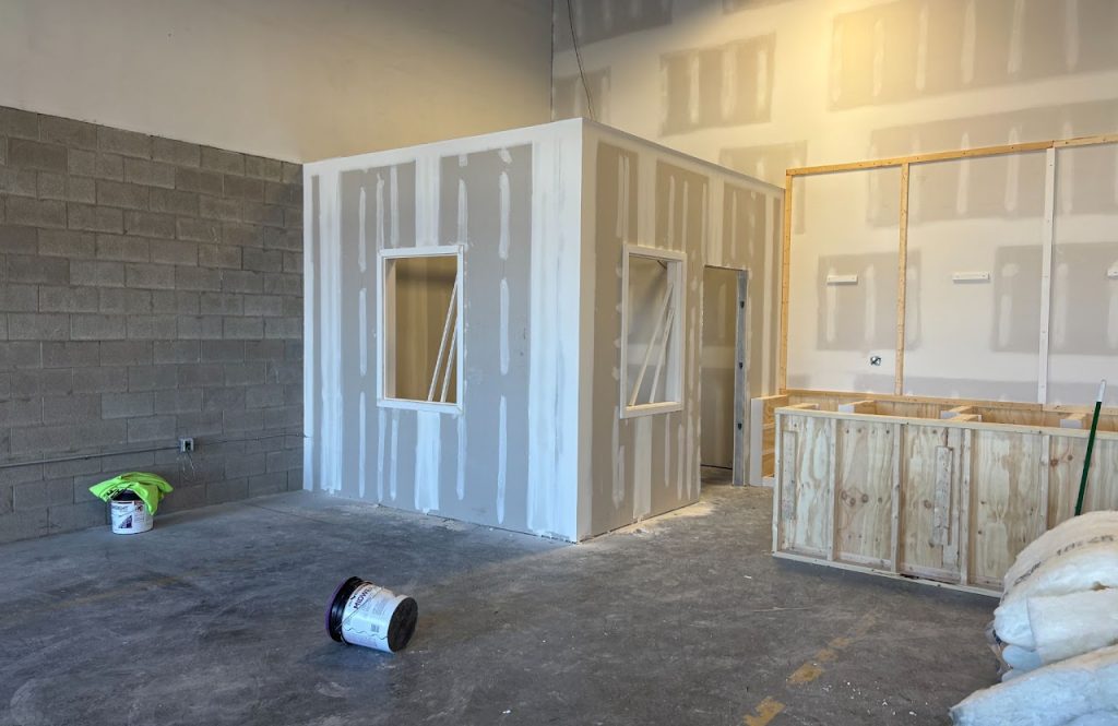 New office walls, windows and reception counter during drywall installation