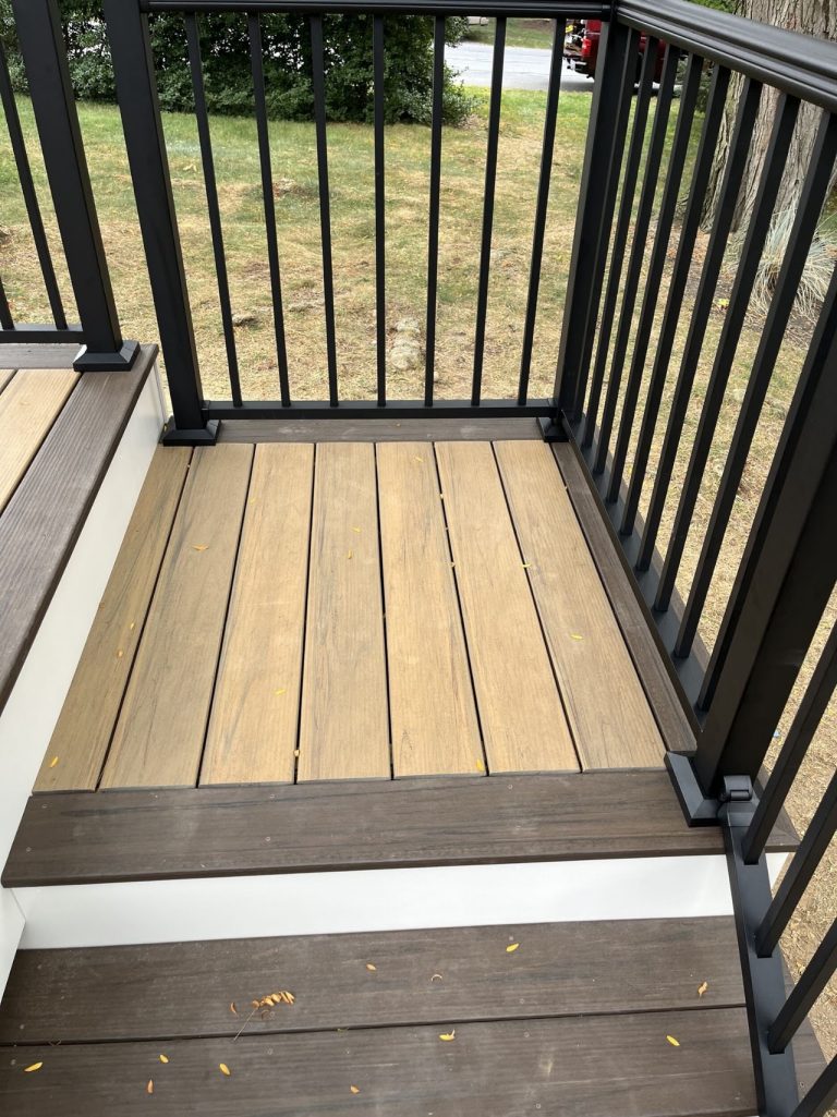 Close view of composite porch boards and black metal guardrail