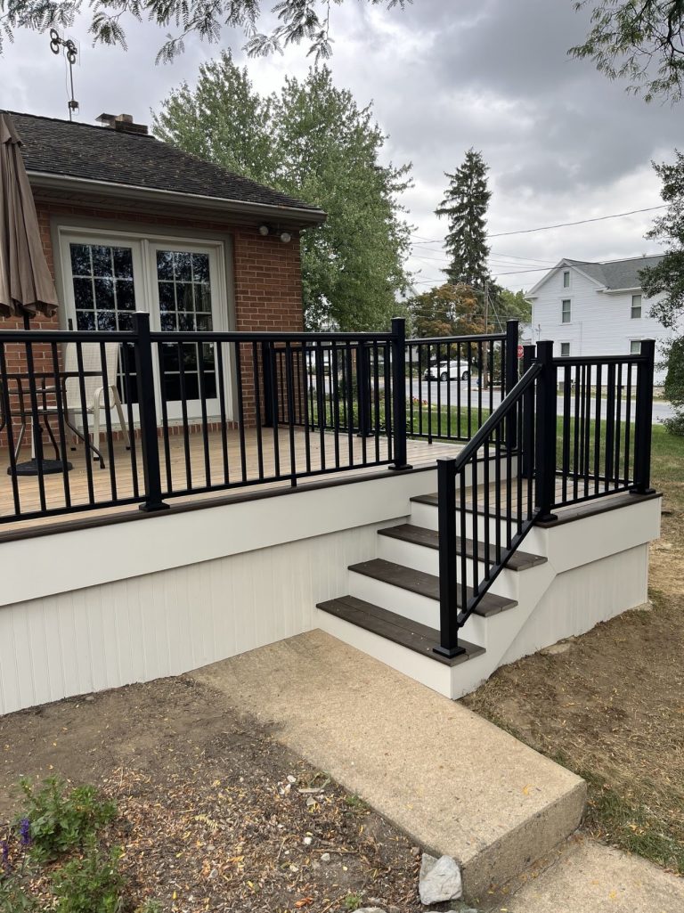 Completed rear porch and stair railing viewed from the driveway