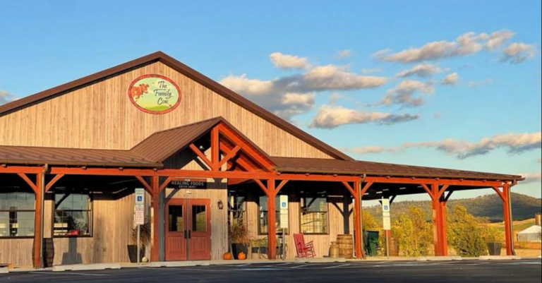 Photograph of the completed Family Cow farm market storefront with timber porch columns and a central entrance.